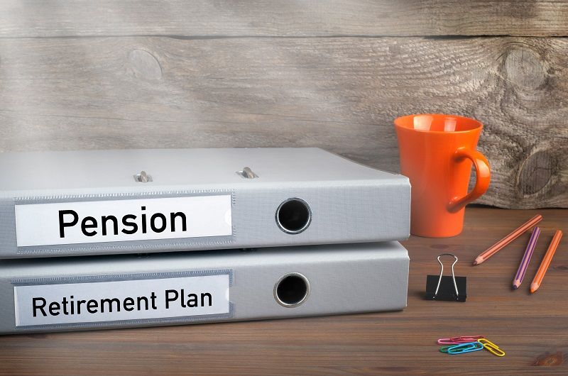Comp Retirement Plan and Pension two folders on wooden office desk