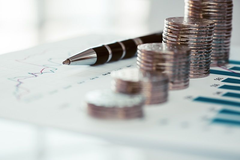 Com Stack of coins with line chart and bar graph