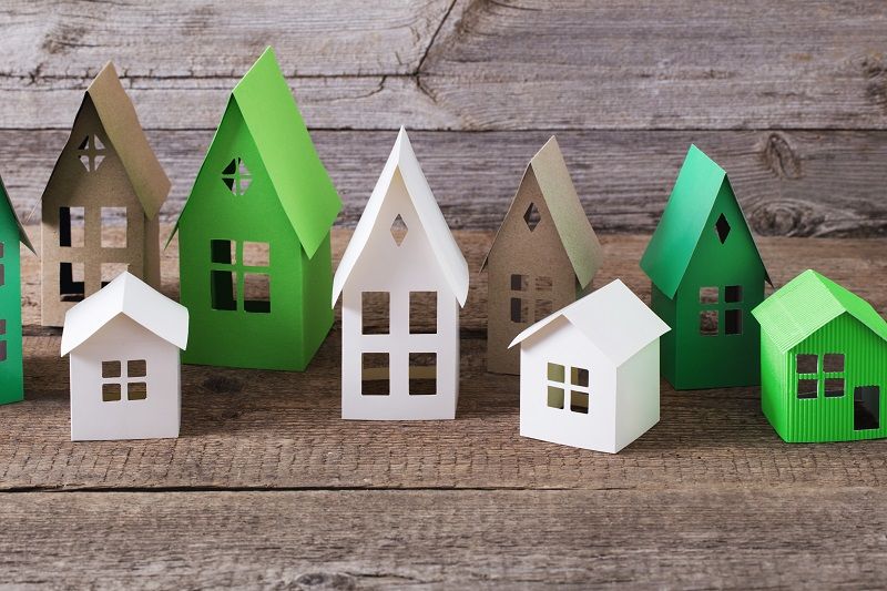 paper house on wooden background cm