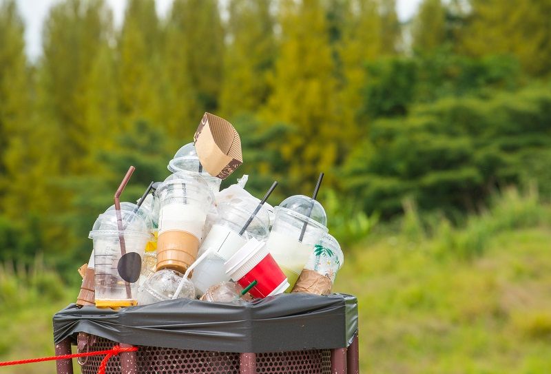 Full of plastic cup in recycle bin in the nature. cm