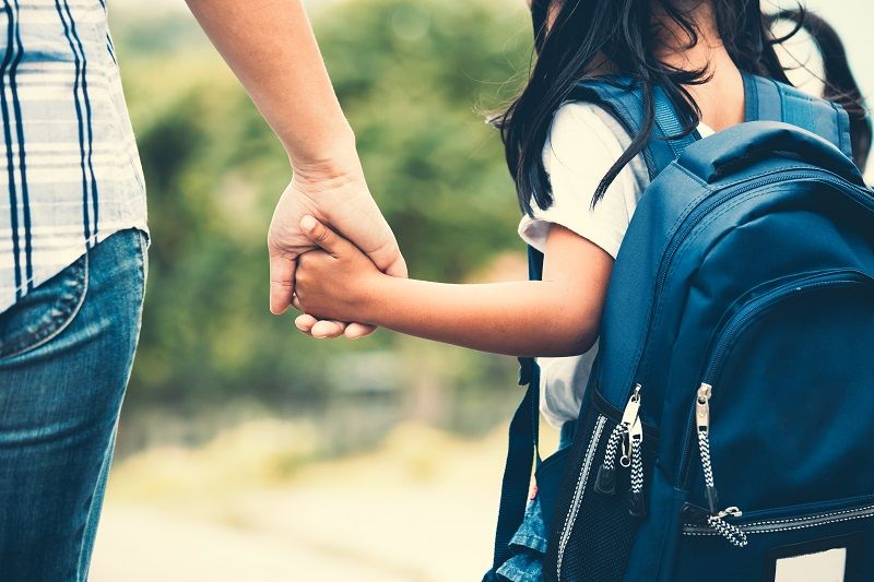 Cute asian pupil girl with backpack holding her mother hand and going to school cm