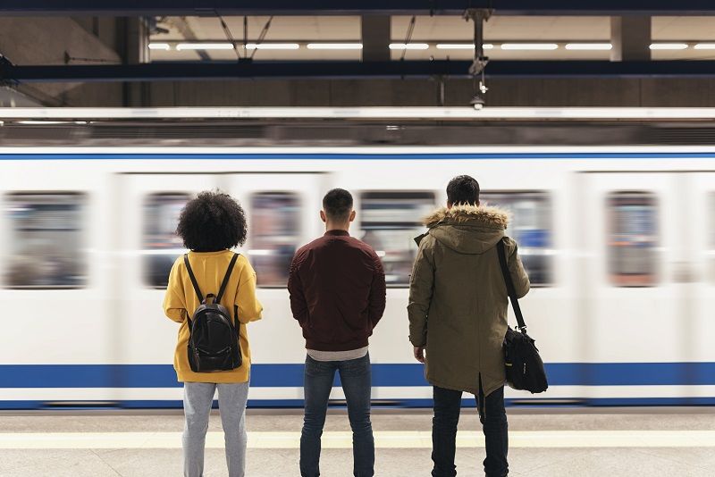 Group of friends waiting the train in the platform of subway station. cm