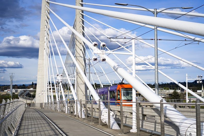 City public transport tram is moving along the cable Tilikum Crossing Bridge cm