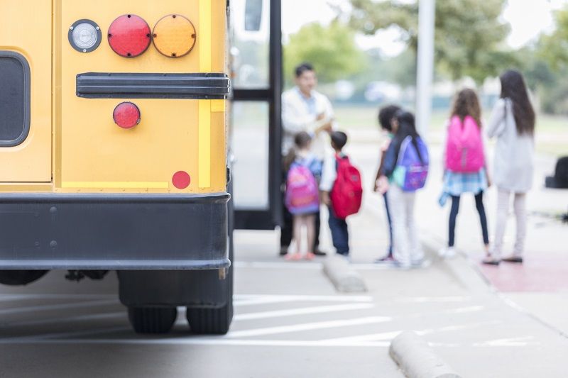 Schoolchildren loading school bus cm