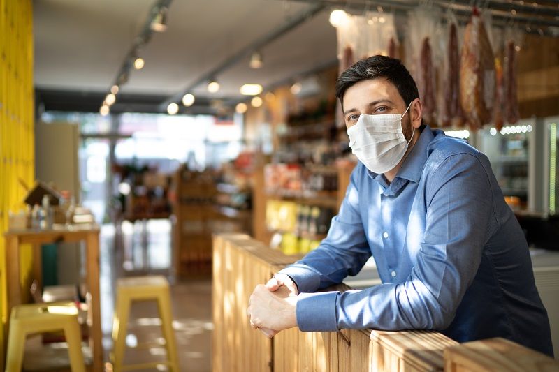 Portrait of small business man owner with face mask cm