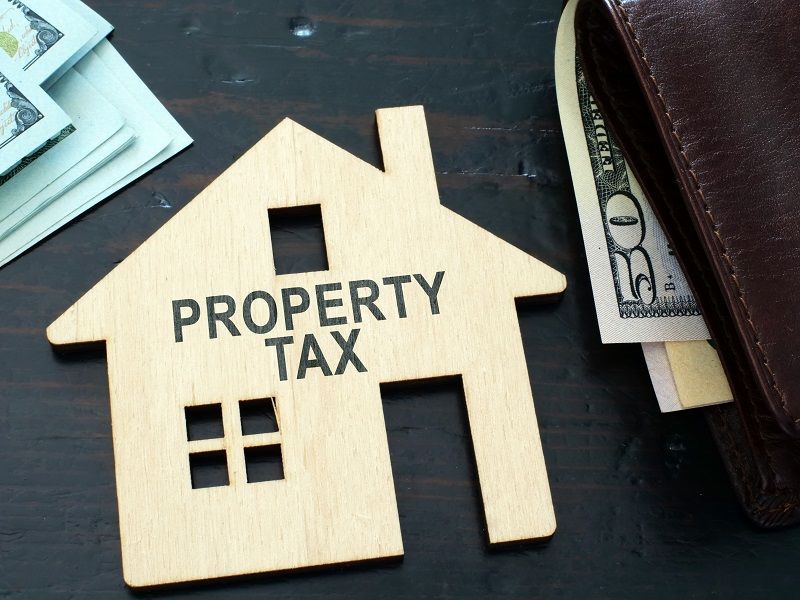 Property tax sign on a house model. cm