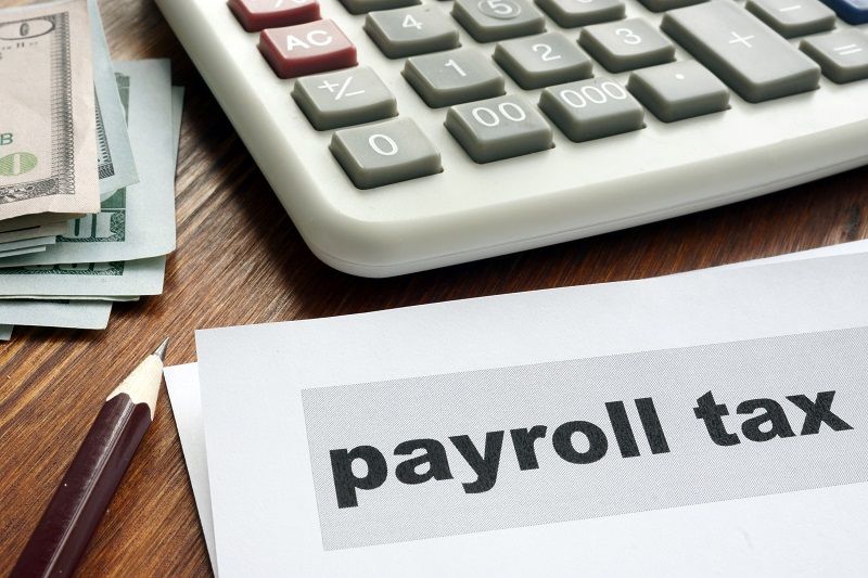 Payroll tax concept. Papers calculator and money cm